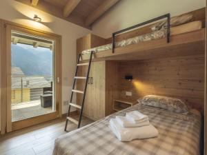 a bedroom with a bunk bed and a ladder at Holiday Home Guarnelle House 2 by Interhome in Bianzone