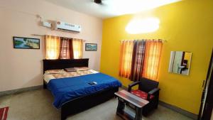 a small bedroom with a bed and a chair at Kushi Home Stay in Visakhapatnam +25 photos