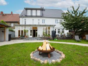 a fire pit in a yard in front of a house at Apartment Georg by Interhome in Mirow