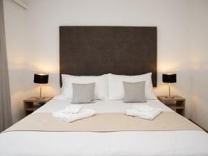 a bedroom with a bed with two towels on it at Apartment La Siala Apt-17 by Interhome in Falera
