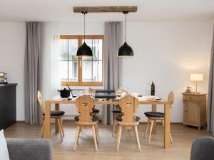 a kitchen and dining room with a table and chairs at Apartment La Siala Apt-17 by Interhome in Falera +43 photos