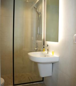 a bathroom with a white sink and a shower at Abu Alsoud Hotel in Amman +14 photos