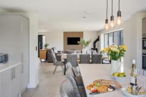 a kitchen and living room with a table with food on it at Blackhills Barn - Crosby in Northallerton