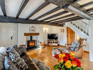 a living room with a couch and a fireplace at 3 Bed in Hawkshead 54193 in Hawkshead