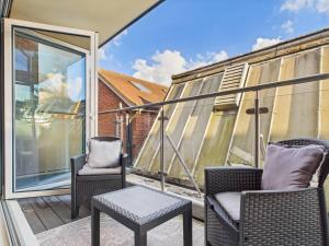 two chairs and a table on a balcony at Stylish 2 Bedroom Flat | Sleeps 4 | in Brent Station