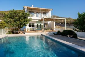 a house with a swimming pool in front of a house at AK-Green Villa near Athens Airport in Vravrona
