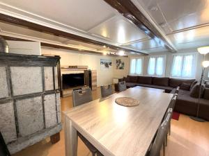 a living room with a table and a couch at Chalet-Etage Mitten im Dorf in Leukerbad +27 photos