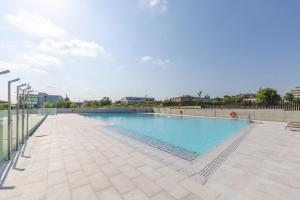 a large swimming pool with blue water at Be Casa Alcobendas in Alcobendas