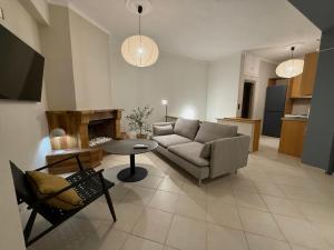 a living room with a couch and a table at Komi beach Maisonette in Kómi