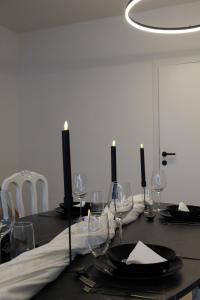 a dining room table with a black table cloth and candles at Diesters huisje in Diest