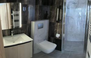 a bathroom with a toilet and a sink and a shower at Garden and Sea in Nikiti +19 photos