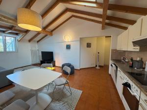 a kitchen and living room with a table and chairs at Special apartment in Ascona in Ascona
