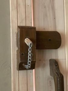 a wooden door with a chain attached to it at ANCIENT STAY by MANOKUR- E- BASA in Minapin