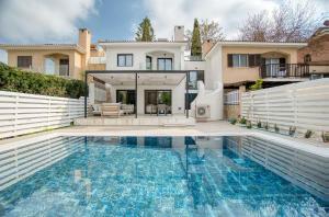 a swimming pool in front of a house at River Pearl Villa in Tala