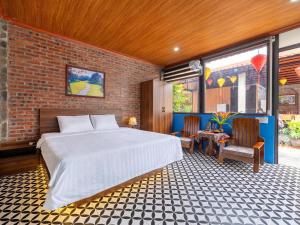 a bedroom with a bed and a brick wall at Chilling Homestay - Hotel in Vũ Lâm +49 photos