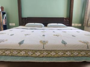 a bed with a blanket with birds on it at not applicable! in Kaikalapettai +154 photos
