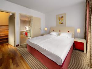 a bedroom with a large bed and a bathroom at Mamaison Residence Diana in Warsaw +60 photos