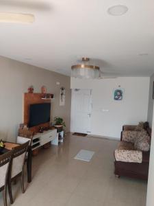 a living room with a couch a table and a tv at not applicable! in Kaikalapettai
