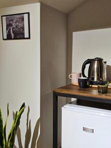 a tea kettle on a shelf on top of a refrigerator at Lemon Garden in Gjirokastër
