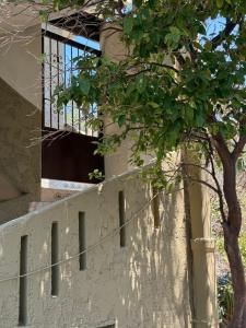 a building with a window and a tree at Retro Groove in Palaiochora