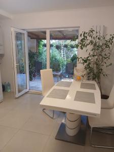 a white table and chairs in a living room at Vila Eduard in Mamaia Sat/Năvodari