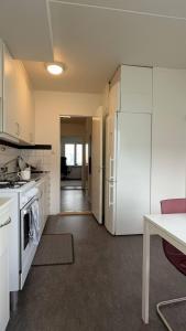 a kitchen with white appliances and a white refrigerator at Liseberg-Near Apt City Centre WOW Fest in Gothenburg +15 photos