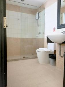 a bathroom with a shower and a toilet and a sink at The Star House in Patong Beach