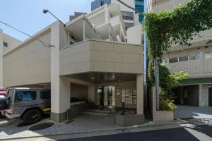 a building with a van parked in front of it at Shibuya E-address 205 in Tokyo