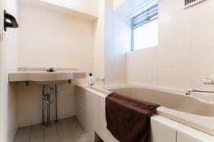 a bathroom with a sink and a bath tub and a sink at Shibuya E-address 205 in Tokyo +17 photos