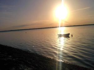 a boat in the water with the sun in the sky at Tranquil Retreat in Hejlsminde-By Traum in Hejls