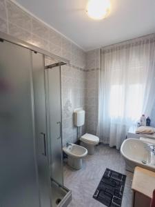 a bathroom with a shower and a toilet and a sink at Siderea House in Chioggia