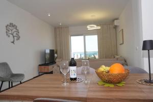 a table with two wine glasses and a bowl of fruit at Belvedere at Emerald Residence Bar in Bar