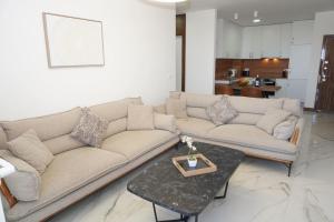a living room with a couch and a table at Belvedere at Emerald Residence Bar in Bar +50 photos