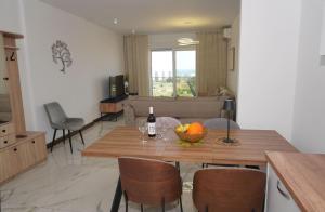 a kitchen with a table with a bowl of fruit on it at Belvedere at Emerald Residence Bar in Bar