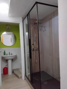 a bathroom with a shower and a sink at Suite House in Sora