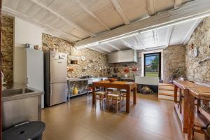 a kitchen with a table and a refrigerator at Villa 326 in Esposende