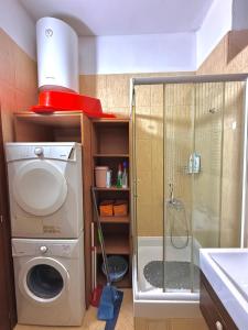 a bathroom with a washing machine and a shower at Bokeska apartment in Podgorica +14 photos