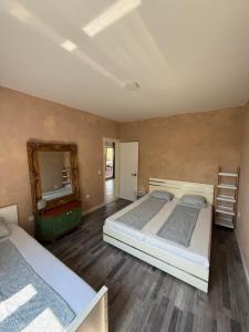 a bedroom with two beds and a mirror at Holiday Home Oliva in Novalja