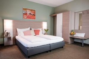 a bedroom with a large bed in a room at Hotel Raffel in Jennersdorf +44 photos