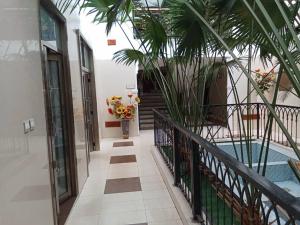 a hallway of a building with a pool and palm trees at Lake 47 Suites Ltd in Abuja