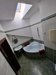 a bathroom with a bath tub and a sink at Pensjonat Oleńka in Ustka +43 photos