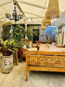 a room with a bed and tables and plants at Keiraleagh House in Wollongong