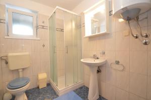 a bathroom with a toilet and a sink and a shower at Apartmani Raić in Mali Lošinj +21 photos