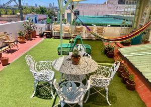 a patio with a table and chairs and a playground at Stylish Art Déco Mexican House with rooftop in Guadalajara