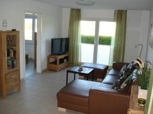 a living room with a couch and a tv at "CASA-MARE" Fehmarn in Wulfen auf Fehmarn
