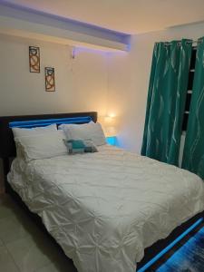 a bed with a teddy bear sitting on top of it at Lawrence Legacy 2 in Saint Georgeʼs