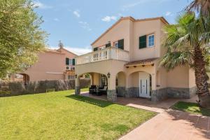 a large house with a balcony and a yard at Villa Laurax in Son Carrio