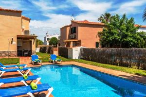 a villa with a swimming pool and a house at Villa Laurax in Son Carrio
