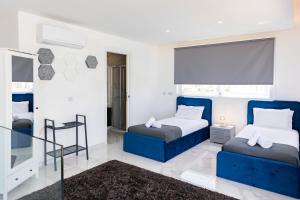 a bedroom with two beds and a window at Villa Ixoria Unit 2 with Rooftop Pool by ArcoBnb in St Julian's +21 photos