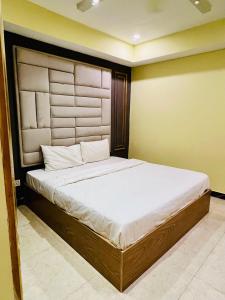 a bedroom with a large bed in a room at Modern 2-Bedroom Apartment Only For Families in E-11 Northern strip in Islamabad